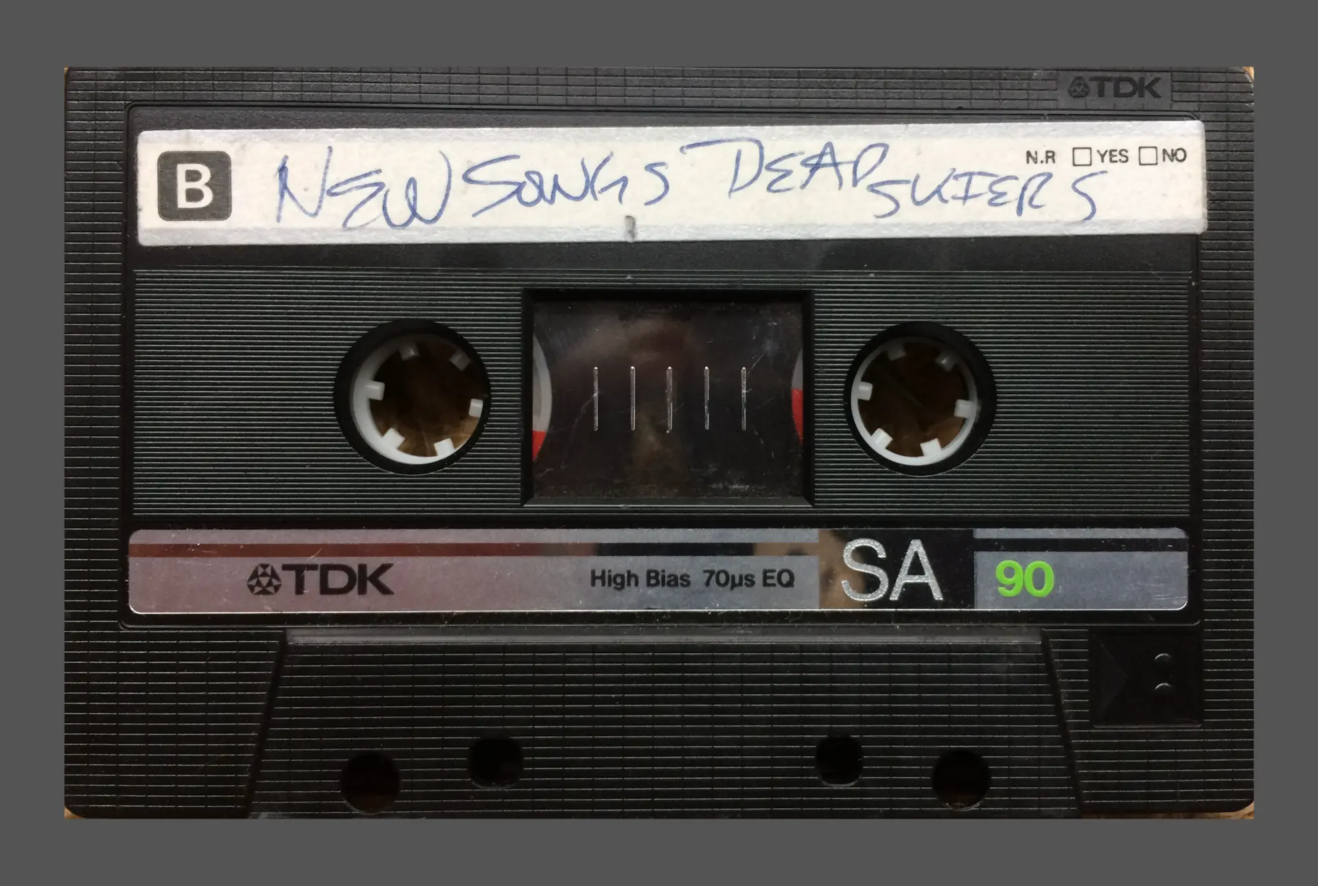 Black TDK SA 90 cassette with a handwritten label reading Dead Skiers, photographed close-up
