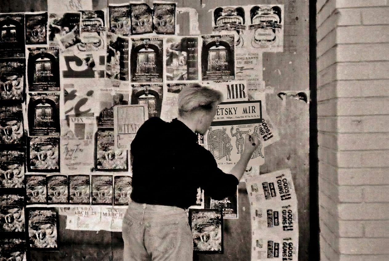 Grainy black-and-white photograph of Reid promoting an upcoming show on a downtown San Jose poster wall in 1989